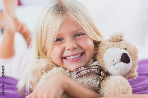 Photo: Blonde girl embracing her teddy bear Blonde girl embracing her teddy bear