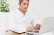 Serious man using his laptop