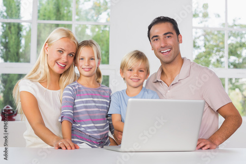 Photo: Happy family using a laptop together Happy family using a laptop together