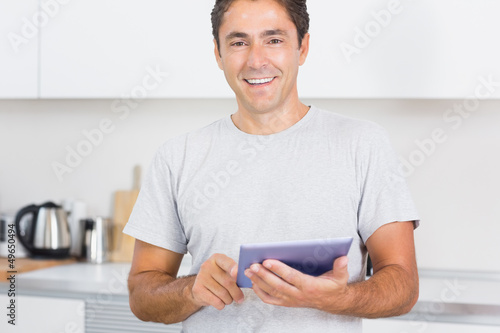 Photo: Smiling man using tablet Smiling man using tablet
