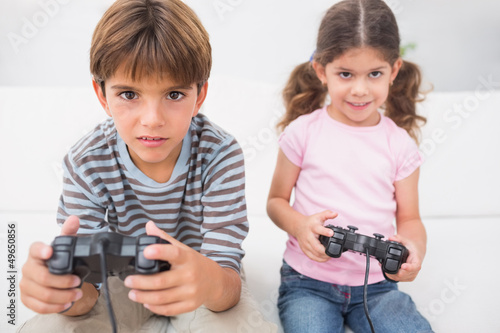 Photo: Brother and sister playing video games Brother and sister playing video games