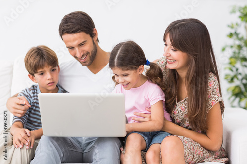 Photo: Family using laptop together Family using laptop together