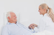 Doctor comforting elderly patient
