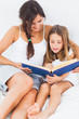 Mother and her daughter looking at a photo album