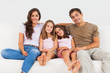 Cute family sitting on a sofa