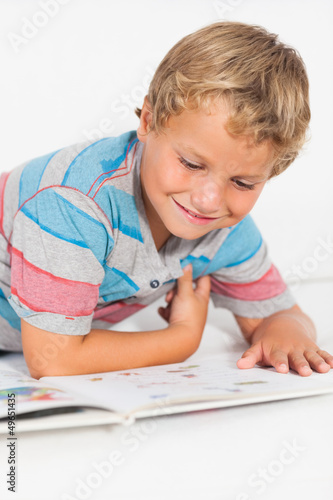 Photo: Happy boy reading a storybook Happy boy reading a storybook