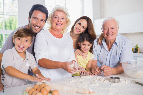 Photo: Smiling family baking together Smiling family baking together