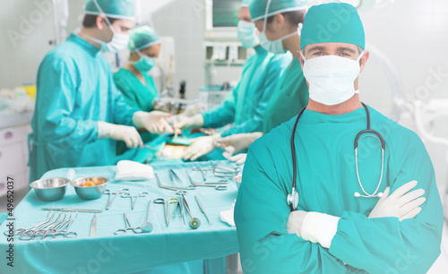 Photo: Side view of a medical team operating Side view of a medical team operating