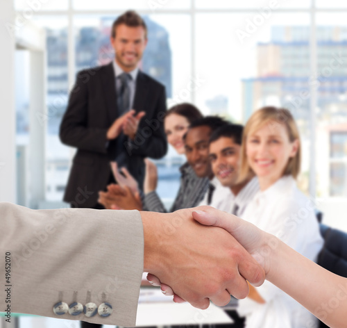 Photo: Businessman and woman shaking hands Businessman and woman shaking hands