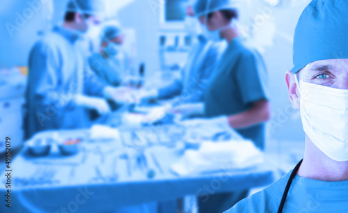 Photo: Side view of a medical team operating Side view of a medical team operating