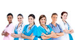 Smiling female hospital workers standing arms folded in line
