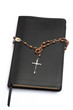 Rosary beads wrapped around the bible