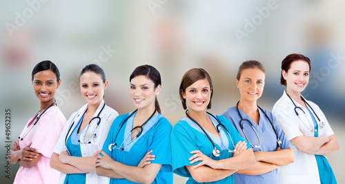 Photo: Female hospital workers standing arms folded Female hospital workers standing arms folded