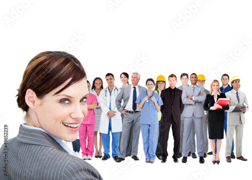 Photo: Smiling businesswoman ahead a group of people with different job Smiling businesswoman ahead a group of people with different job
