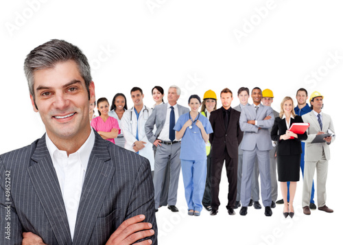 Photo: Smiling businessman ahead a group of people with different jobs Smiling businessman ahead a group of people with different jobs