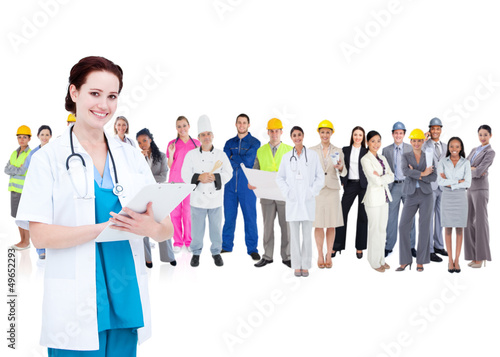 Photo: Pretty doctor standing in front of diverse career group Pretty doctor standing in front of diverse career group