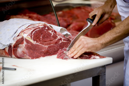 Photo: butcher cutting meat butcher cutting meat