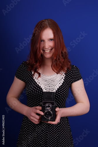Photo: smiling woman in polka dot dress with old TLR camera smiling woman in polka dot dress with old TLR camera