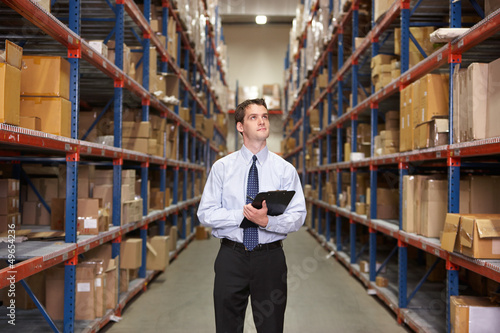 Photo: Manager In Warehouse With Clipboard Manager In Warehouse With Clipboard