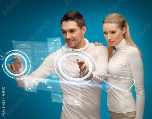 Photo: man and woman working with virtual screens man and woman working with virtual screens