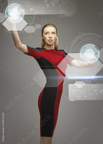 Photo: woman working with virtual touchscreens woman working with virtual touchscreens