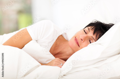Photo: cute mature woman sleeping on bed cute mature woman sleeping on bed