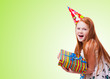 happy little girl with gift box on green background