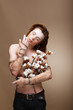 Authentic Handsome Man with Flowers standing in Studio