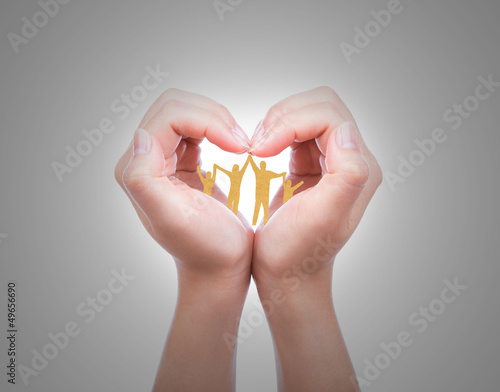 Photo: Hand with the paper cut of the family Hand with the paper cut of the family