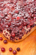 closeup sweet pie with fresh cowberry and cranberry on wooden