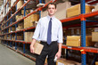 Photo: Businessman With Package And Scanner In Warehouse Businessman With Package And Scanner In Warehouse