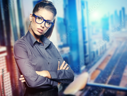 Photo: Portrait of cute young business woman outdoor over building back Portrait of cute young business woman outdoor over building back