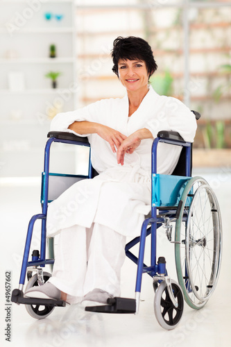 Photo: middle aged woman sitting on wheelchair recovering from injury middle aged woman sitting on wheelchair recovering from injury