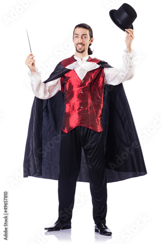 Photo: Magician with his magic wand on white Magician with his magic wand on white