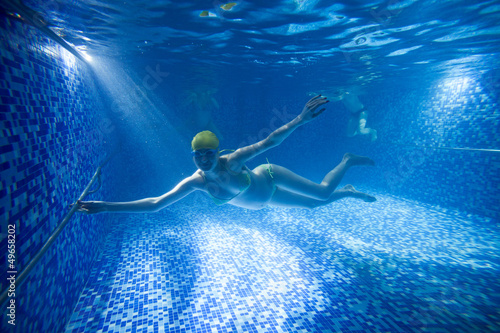 Photo: Young pregnant woman underwater in swimming pool Young pregnant woman underwater in swimming pool