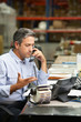 Photo: Manager Working At Desk In Warehouse Manager Working At Desk In Warehouse
