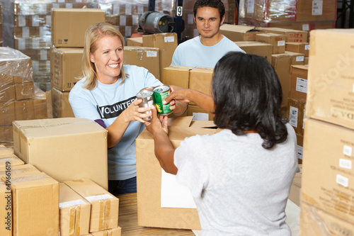 Photo: Volunteers Collecting Food Donations In Warehouse Volunteers Collecting Food Donations In Warehouse