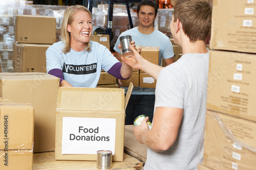 Photo: Volunteers Collecting Food Donations In Warehouse Volunteers Collecting Food Donations In Warehouse