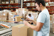 Worker Using Tablet Computer In Distribution Warehouse