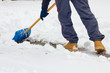 Close-up as man shovels snow