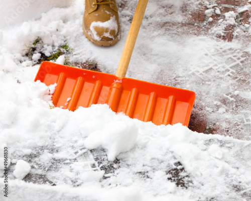 Photo: Close-up as man shovels snow Close-up as man shovels snow