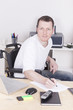 young man in wheelchair  at home office