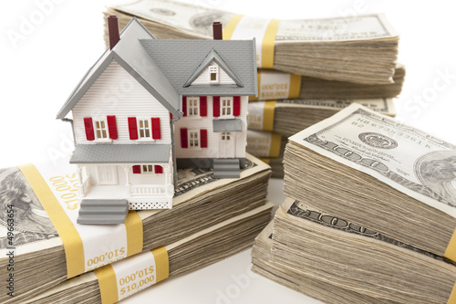 Photo: Stacks of Hundreds of Dollars with Small House Stacks of Hundreds of Dollars with Small House