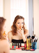 Portrait of attractive woman applying parfume