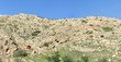 Photo: Texture of a layered sedimentary rock under the blue sky Texture of a layered sedimentary rock under the blue sky