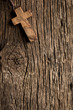 antigue wooden cross on old wooden background