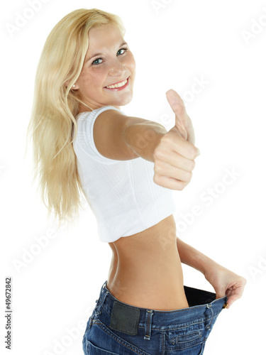 Photo: Beautiful girl is proud to lose weight - showing thumb up Beautiful girl is proud to lose weight - showing thumb up