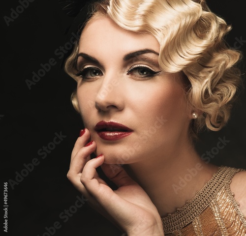 Photo: Elegant blond retro woman in golden dress Elegant blond retro woman in golden dress