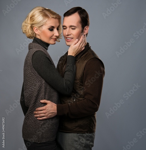 Photo: Young man and woman in casual brown wear Young man and woman in casual brown wear