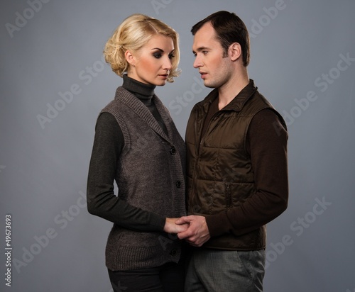 Photo: Young man and woman in casual brown wear Young man and woman in casual brown wear